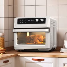 a chicken is cooking in an oven on the counter