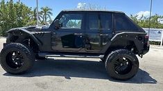 a black jeep parked in a parking lot