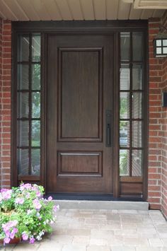 the front door is brown and has flowers in it