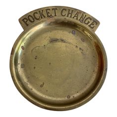 an old metal plate with the words pocket change on it