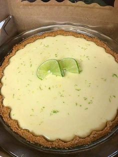 there is a pie with limes on it in the box, ready to be eaten