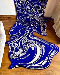 a blue area rug with white swirls on it