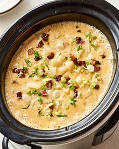 a crock pot filled with potatoes and bacon