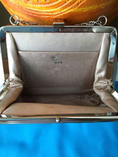 an open purse sitting on top of a blue table