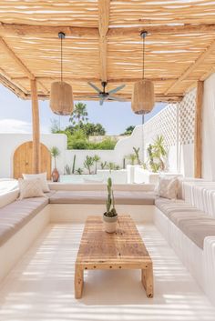 an outdoor living area with couches and tables