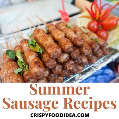 grilled sausage skewers with lettuce and tomatoes on the side in a tray