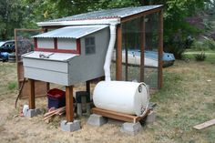 a chicken coop with a water tank next to it