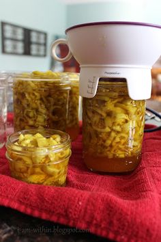 jars filled with food sitting on top of a red towel