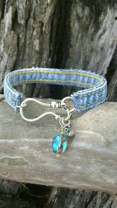 a bracelet with a blue bead and a silver charm hanging from it's end