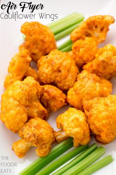 cauliflower wings on a plate with celery sticks