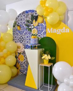 balloons and flowers are on display in front of a backdrop for a birthday party at magda