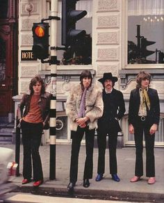 the rolling stones are standing in front of a traffic light