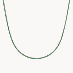 The Evergreen Tennis Necklace from our Eden Collection embodies the radiant beauty of the Garden of Eden. Available in widths of 1.70 mm and 3 mm and lengths of 35 cm and 40 cm, this necklace is adorned all around with sparkling emeralds set in 14kt recycled gold. The emeralds shine in an intense green and have been meticulously set by hand to enhance their natural brilliance. The Evergreen Tennis Necklace is a timeless piece of jewelry that adds a special touch to any outfit and stands out with Green Emerald Necklace With Adjustable Chain, Green Emerald Jewelry With Delicate Chain, Minimalist Green Emerald Necklace With Delicate Chain, Elegant Green Cable Chain Necklace, Elegant Green Round Chain Necklace, Elegant Green Jewelry With Box Chain, Classic Green Necklace For May Birthstone, Classic Green Single Strand Necklace, Minimalist Green Emerald Necklaces