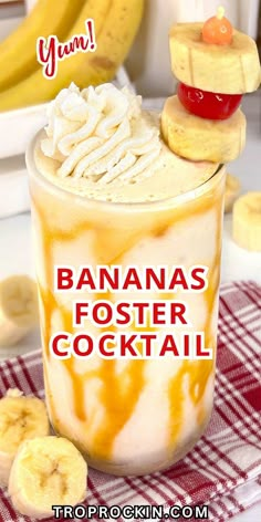 a banana fosterer cocktail with whipped cream and bananas on top, sitting on a red checkered tablecloth