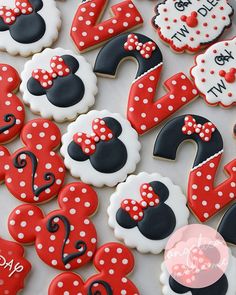 some decorated cookies are sitting on a white table with red and black polka dot designs