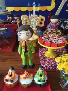 an assortment of cupcakes and cakes on display in a children's birthday party