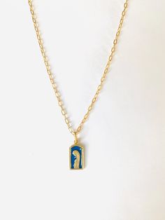 Blue and gold Blessed Mother Necklace 18 inches long. The chain is a gold filled chain.  The charm is Vermeil (gold plate over sterling silver), beautiful blue *guilloche enamel. *Guilloche is a decorative technique in which a precise, intricate, and repetitive pattern is engraved into an underlying material via engine turning, which uses a machine called a rose engine lathe.  The charm was manufactured in France in the 1940's and the plant closed in 1950. This is a brand new charm but vintage in the sense of when it was manufactured.  I was able to acquire only a few of the remaining stock so when these few are gone they cannot be replenished. This is a rare item. Blue Pendant Necklace With Cable Chain, Gold Enamel Necklace With Cable Chain, Blue Engraved Pendant Necklace, Blue Gold-plated Charm Necklace With Adjustable Chain, Blue Cable Chain Necklace For Gifts, Blue Engraved Enamel Necklaces, Blue Engraved Necklace For Gift, Blue Enamel Engraved Necklace, Blue Cable Chain Jewelry As A Gift