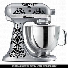 an ornate design on the side of a silver kitchen mixer with black damask decals