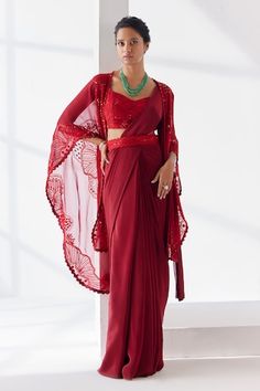 Red pre-draped plain saree crafted in crepe. Paired with a cape sleeves yemeni bloom embroidered cape using tonal thread, sequins, beads, mirror highlights, embellished padded blouse and hand embroidered belt. - Aza Fashions Elegant Red Pre-draped Saree For Festive Occasions, Red Fitted Pre-draped Saree With Zari Work, Festive Red Pre-draped Saree With Traditional Drape, Red Fitted Pre-draped Saree For Wedding, Red Pre-draped Saree With Sheer Dupatta For Evening, Red Pre-draped Saree For Formal Festive Occasions, Red Pre-draped Saree For Party, Elegant Red Pre-draped Saree With Sheer Dupatta, Elegant Red Pre-draped Saree For Diwali