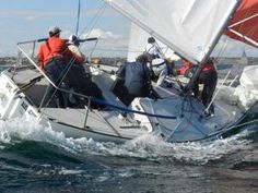 two men on a sailboat in the water