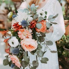 a woman holding a bouquet of flowers in her hands