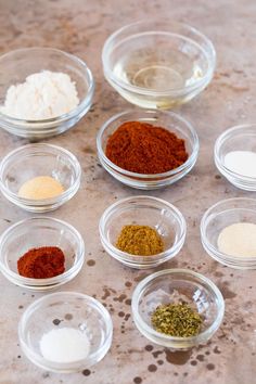 the bowls are filled with different kinds of spices