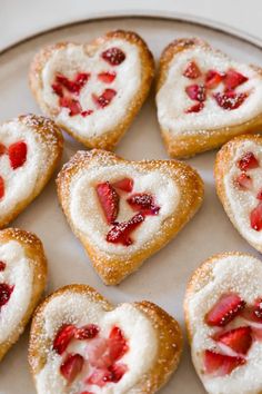 heart shaped pastries are arranged on a plate