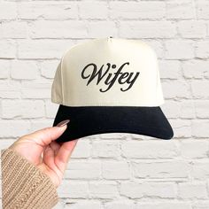 Celebrate your wifey status in style with this Embroidered Wifey Two-Toned Trucker Hat! Perfect for newlyweds, brides-to-be, or anyone proud to wear the "wifey" title, this custom trucker hat features elegant embroidery on a trendy two-toned hat. Whether you're planning a bachelorette party, honeymoon, or just a casual day out, this hat is the perfect accessory for any fun-loving bride or wife! Samples Shown: navy with navy black with black green with hunter green burgundy with burgundy beige with camel Features: Two-Tone, Sturdy, Canvas Fabric Snap Back Closure One Size Fits Most *Please note, this is a trucker hat, and therefore has an oversized fit compared to a traditional baseball hat* Sweatshirt Features: 8-ounce, 50/50 cotton/poly Double-needle stitching at waistband and cuffs 1x1 r Planning A Bachelorette Party, Custom Trucker Hats, Bachelorette Gift, Elegant Embroidery, Bachelorette Gifts, Fun Loving, Snap Backs, Style Expert, Baseball Hat