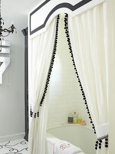 a bath room with a tub and a chandelier hanging from it's ceiling