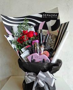 a black and white vase filled with lots of beauty items