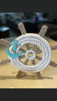 an anchor and rope on top of a wooden table