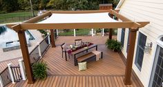 an outdoor patio with table and chairs under a white awning over the dining area