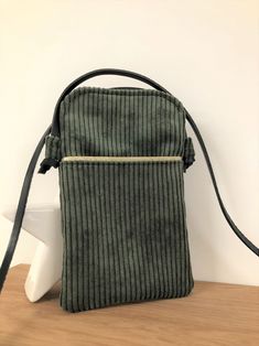 A khaki green shoulder bag for your cell phone in soft corduroy and its knotted leather strap! A trendy mini bag, an ultra practical accessory to carry your smartphone and your essentials while protecting them! Made of corduroy in a choice of pretty colors, they have a front pocket where you can slip your bank card, ID,... They are adapted to all phone sizes from the smallest to the largest and a small invisible magnet closes the pocket, which will open quickly to grab the smartphone. 6 corduroy Tablet Bag, Large Handbags, Phone Pouch, Zip Pouch, Wallet Bag, The Pouch, Shopper Bag, Glasses Case, Khaki Green