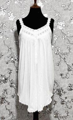 This gorgeous sleeveless Victorian nightgown is made entirely of cotton for the utmost in comfort and softness. It perfectly embodies the beauty and elegance of the Victorian era, embellished with exquisite lace accents. A hint of vintage charm can be added to your evening routine with this dreamy, timeless style created by the lightweight fabric and exquisite lace details. Summer Cotton Nightgown For Loungewear, Summer Nightgown With Lace Trim, White Summer Cami Nightgown, Sleeveless Camisole For Summer Relaxation, Summer Sleeveless Camisole For Relaxation, Summer Lace Trim Nightgown For Loungewear, Summer Nightgown With Lace Trim For Loungewear, Summer Beach Nightgown With Lace Trim, Summer Night Sleeveless Tank Top