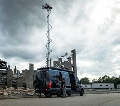 a van is parked in front of a building under construction