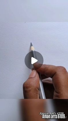 a person is holding a pencil and pointing to the paper with an arrow on it