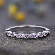 an image of a wedding band with purple stones