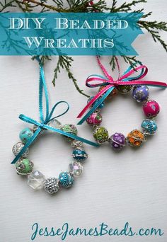 two bracelets with bows tied around them on top of a white surface next to a pine branch