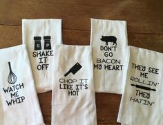 five kitchen towels with words written on them