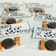 four bags of happy 1st day treats with cookies and oreos in the middle one has an image of a dog on it