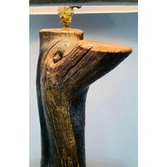 a piece of wood with a light on it's end and a lamp in the background