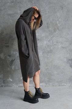 This gray sweatshirt masters cool, off-duty aesthetics. Made from soft cotton this oversized sweatshirt is complete with hood and long sleeves. On the front decorative asymmetrical seams unfinished ends. Large pockets hidden on the side. This sweater is unisex suitable to wear every day. Continue the grunge vibe with an asymmetric dress and sneakers. Cotton 100% Modern design High quality material Handmade item Model is 175cm/ 5''9' and is wearing size S. Size guide XS Bust: 82-85cm, Waist: 62-6 Oversized French Terry Sweatshirt With Drawstring Hood, Oversized French Terry Hoodie, Oversized French Terry Hoodie For Loungewear, Urban Style Long Sleeve French Terry Hoodie, Urban Baggy Sweatshirt For Fall, Oversized Comfy Sweatshirt With Drawstring Hood, Comfy Oversized Sweatshirt With Drawstring Hood, Oversized Black French Terry Hoodie, Urban Oversized Hoodie In French Terry