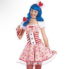 a woman dressed in a clown costume holding two lollipops