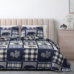 a bed with blue and white checkered bedspread, pillows and pillow cases