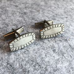 Offering a very nice vintage cuff link set by Danish master Jorgen Jensen in a modernist simple design. These nice pewter cufflinks gleam in the light nicely. A great mid-century look.  Measurements: 1" long x 3/8" tall Weight: 0.4 oz. Brand: Jorgen Jensen signed, style #34 Base metal: Pewter This is perfect for the collector of mid-century style, or to give as a gift.  Sold as-is in pre-owned condition with some surface wear. Catches the light nicely. Clips move and hold position well. Please see all photos as they are part of the description and show item condition.  Ships to you from our smoke-free studio.  The items you receive will be the exact items pictured. Tuxedo Fashion, Modern Silver Cufflinks, Vintage Hallmarked Cufflinks For Formal Wear, Vintage Screw Back Cufflinks As Gift, Antique Cufflinks, Groom Tuxedo, Vintage Silver Screw Back Cufflinks, Tie Clips, Tie Tack