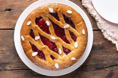 a pie on a plate next to a cup of coffee