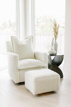 a white chair and ottoman in a room