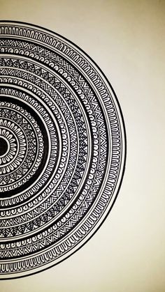 a black and white drawing of an intricate design on a wall in a room with beige walls