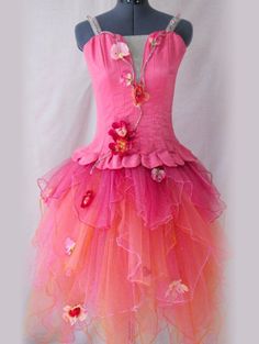 a pink and orange dress on a mannequin headdress with flowers in the center