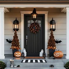 front porch decorated for halloween with pumpkins and decorations